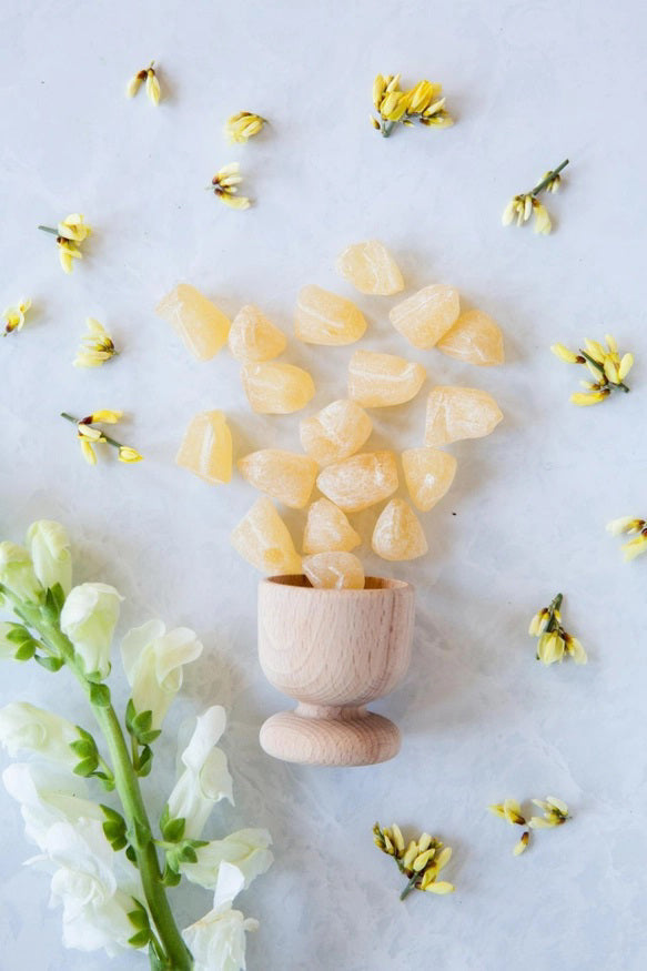 A white pouch labeled "BUTTERFIELDS - GINGER BUDS" shows ginger root and flower. The packaging highlights "Hard candy with a savory natural ginger tang," "Gluten Free," "BUTTERFIELDS," and "Net Wt 2.5oz (60 grams).