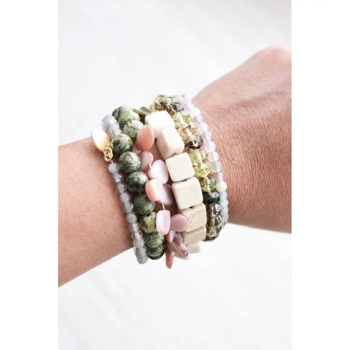 The DAVID AUBREY ATHENA Agate, Jasper, Pearls, and Glass Wrap Bracelet features handcrafted green, white, gold, and pink beads of varying shapes—some with gray agate—coiled together and displayed on a gray background.