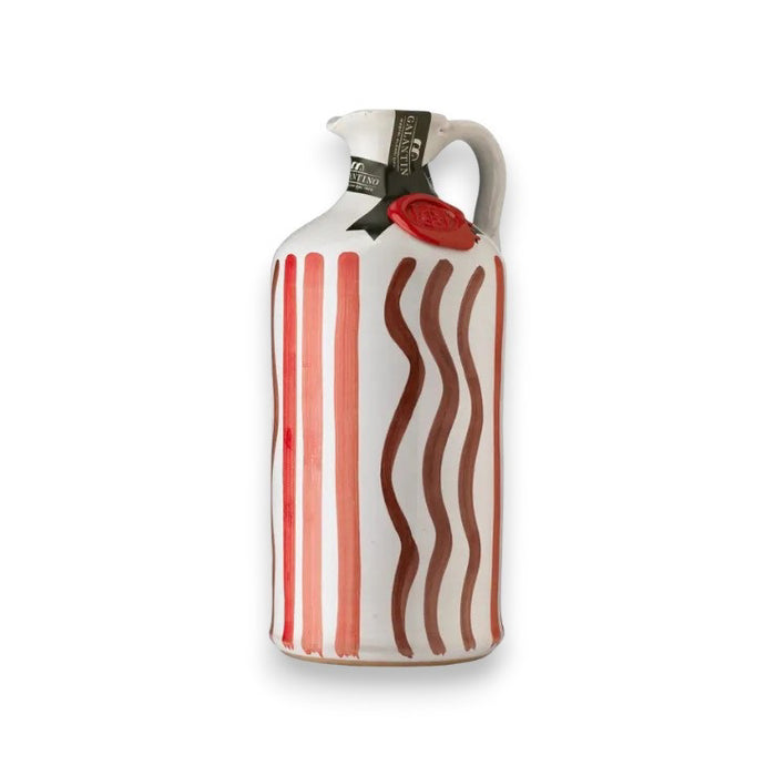 The GALLANTINO - EXTRA VIRGIN OLIVE OIL by ZIA PIA IMPORTS comes in a hand-painted ceramic bottle with a handle, red stripes, wavy brown lines, a green neck label, and a red wax seal. Made in Italy. Background is plain white.
