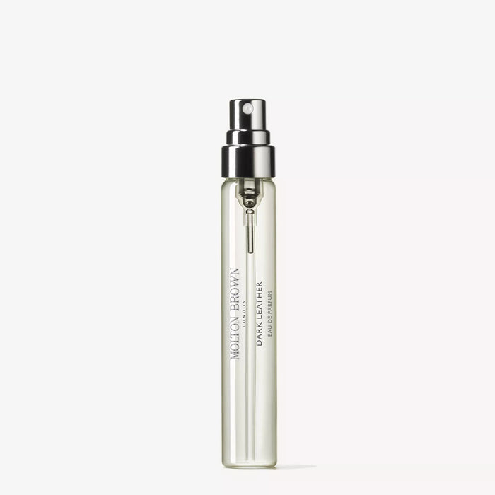 A clear glass bottle of MOLTON BROWN Dark Leather Travel Eau de Parfum 0.25fl oz with a silver nozzle sits on a white background, revealing an elegant woody fragrance with smoky leather notes for a sophisticated scent.