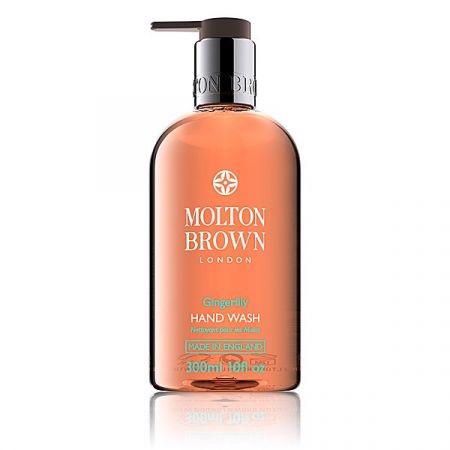 A clear 300ml MOLTON BROWN Heavenly Gingerlily Hand Wash bottle with a pump, filled with orange liquid and enriched with white lily extract.