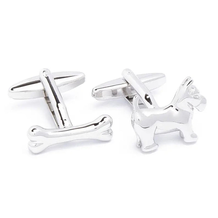 STOLEN RICHES - DOG AND BONE CUFFLINKS by STOLEN RICHES: a unique cufflink set featuring one dog and one bone shape in shiny silver—distinctive men’s accessories and a perfect gift for him, displayed on a white background.