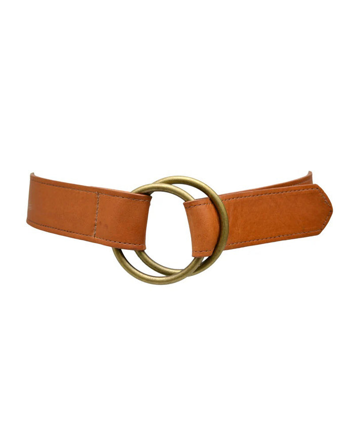 The ADA - JOSIE BELT by ADA is a brown leather belt featuring two overlapping brass rings as the buckle, displayed flat on a white background.