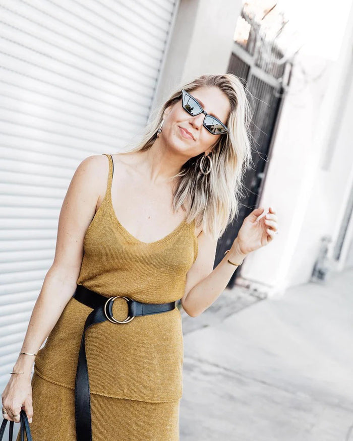 The ADA - JOSIE BELT by ADA is a brown leather belt featuring two overlapping brass rings as the buckle, displayed flat on a white background.