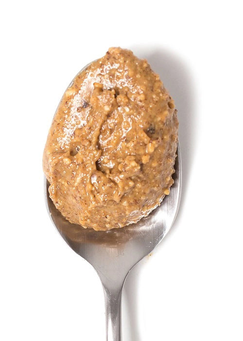 A jar of BIG SPOON ROASTERS - CHAI SPICE PEANUT ALMOND SEA SALT NUT BUTTER, featuring a gold lid and a white, purple, and gold label that highlights its handcrafted Masala Chai blend for bold chai spice flavor.