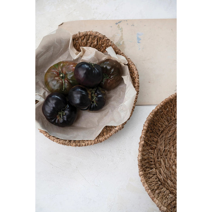 Two round, natural brown BRAIDED BANKUAN BOWLS WITH SCALLOPED EDGE by CREATIVE COOP are displayed side by side on a white background, with the large basket slightly bigger than the other.