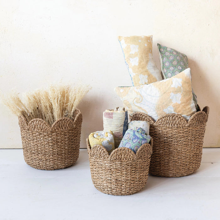 The CREATIVE COOP BRAIDED BANKUAN & RATTAN BASKET (LARGE) features eco-friendly, light brown natural fibers and scalloped edges, providing stylish storage and organization against a plain white background.