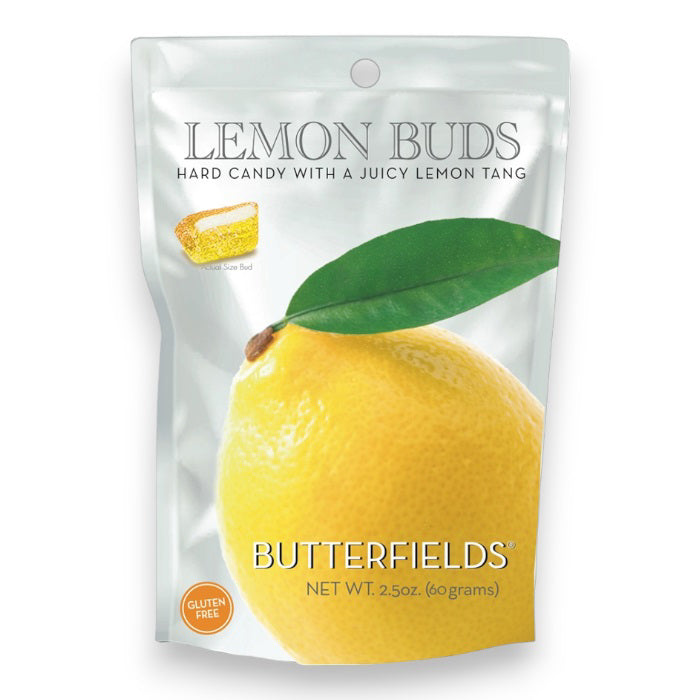 A 2.5oz (60g) bag of BUTTERFIELDS - LEMON BUDS hard candy by BUTTERFIELDS, featuring a large lemon with a green leaf on the front. The gluten-free packaging highlights a hand-squeezed lemonade flavor.