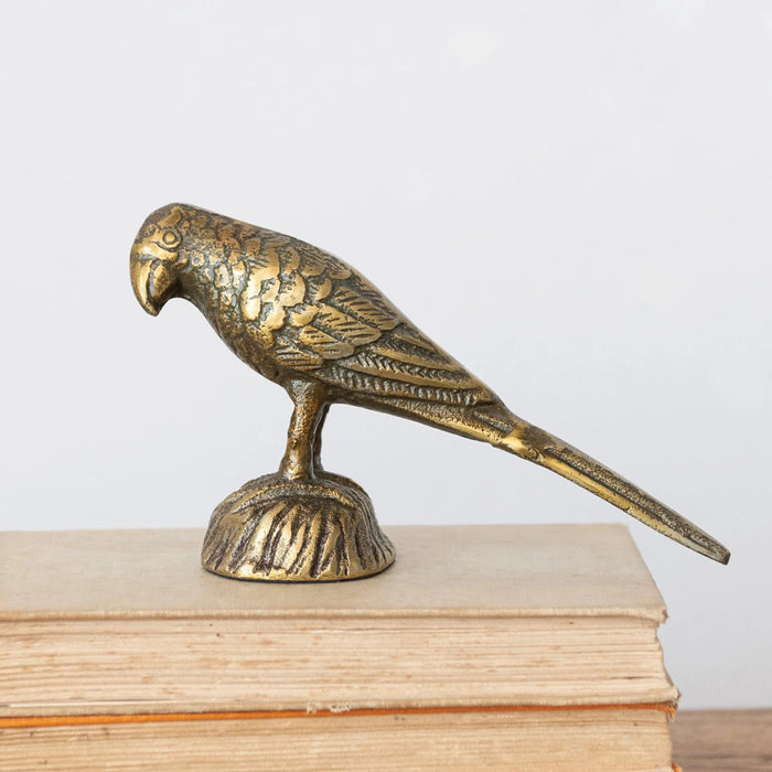 The CREATIVE COOP CAST ALUMINUM BIRD figurine features detailed feathers, a long tail, and an antique metallic finish. Standing on a textured base, it's the perfect decorative accent to enhance your home décor.