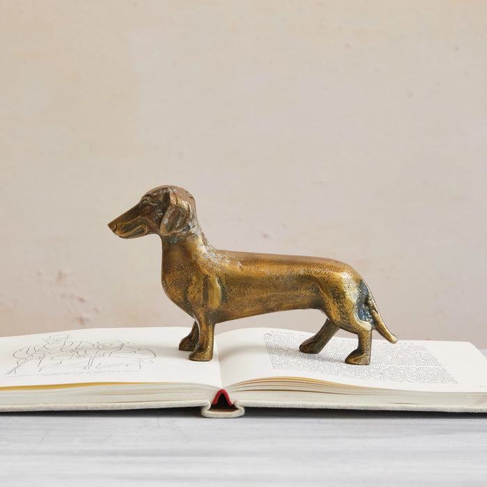 The CREATIVE COOP CAST ALUMINUM DACHSHUND stands on all four legs in profile against a white background—ideal as charming dachshund accent decor.