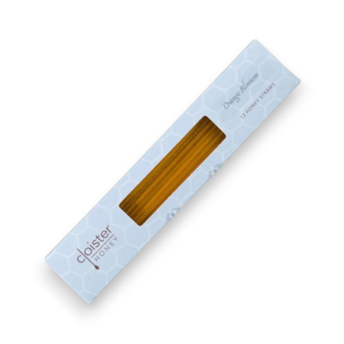 A white, rectangular box containing Cloister Honey - Orange Blossom Honey Straws. The box features a subtle honeycomb pattern and a transparent window showcasing the healthily snackable honey straws inside. Text on the box reads "Cloister Honey" and "12 Honey Straws," highlighting 100% pure, raw natural honey.