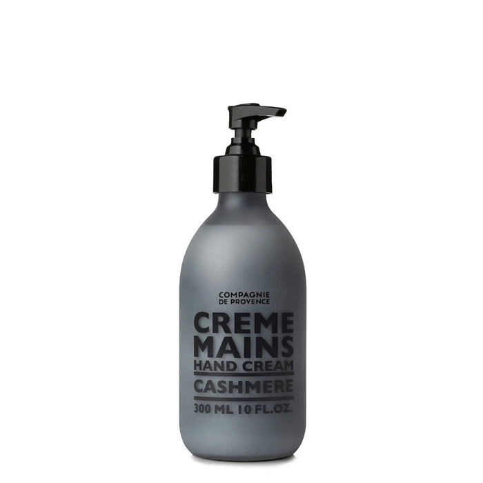 A grey bottle with a black pump, labeled "CIE LUXE BRANDS COMPAGNIE DE PROVENCE CASHMERE HAND CREAM," contains shea butter and woody, spicy notes; it holds 300 ml (10 fl oz).