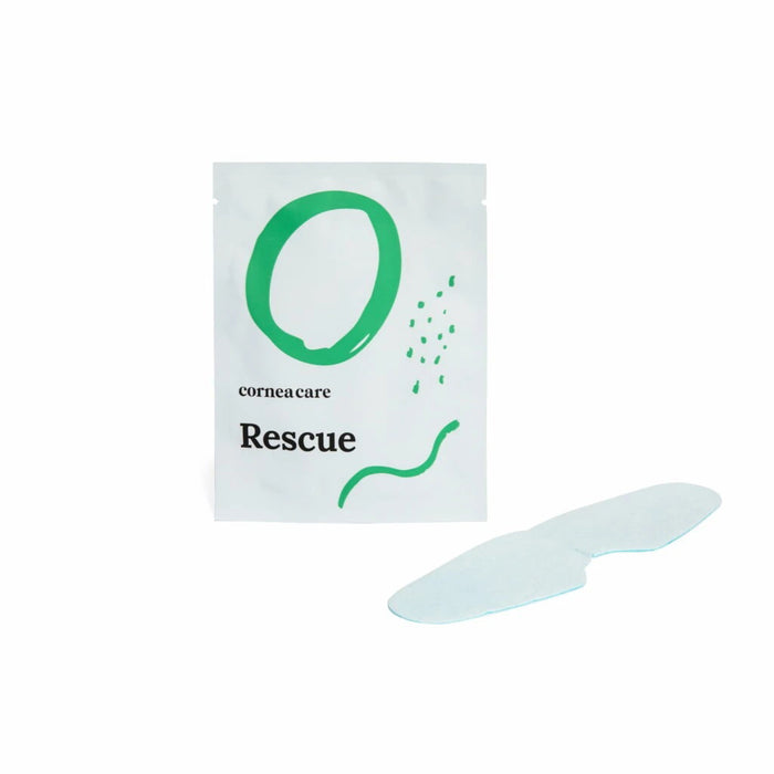 A white pouch with green designs reading "CORNEACARE - RESCUE SELF COOLING EYE MASK" by CORNEA CARE is shown next to a light blue, under-eye shaped mask. It offers soothing relief for eye care and dry eyes. The backdrop is plain white.