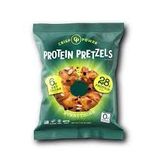 A green bag of CRISP POWER - PROTEIN PRETZEL EVERYTHING by CRISP POWER features a pretzel image and prominently displays 28g protein, 6g net carbs, and 0g sugar on the packaging. These high fiber, plant-based snack protein pretzels are perfect for fueling your day.