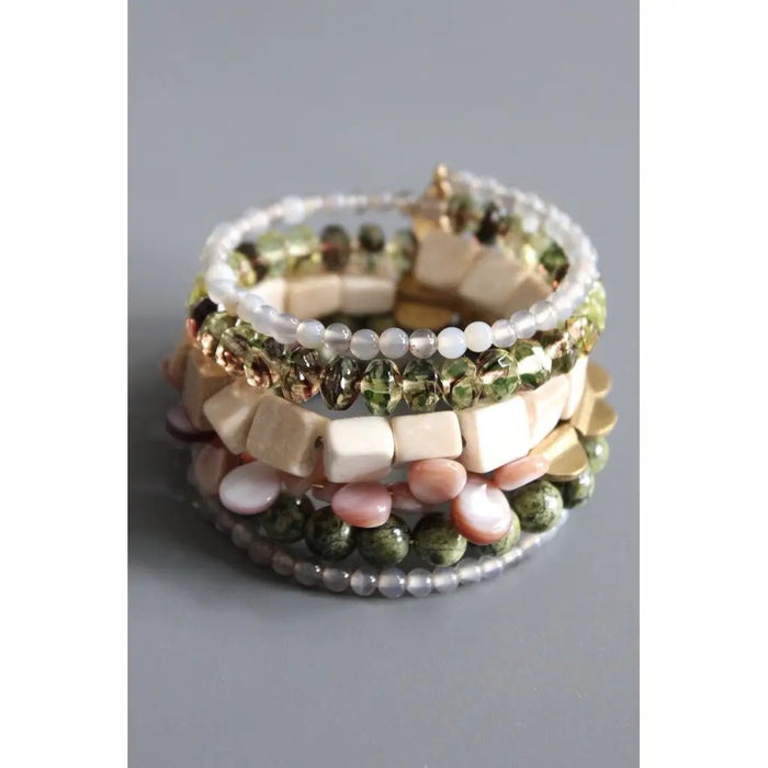 The DAVID AUBREY ATHENA Agate, Jasper, Pearls, and Glass Wrap Bracelet features handcrafted green, white, gold, and pink beads of varying shapes—some with gray agate—coiled together and displayed on a gray background.