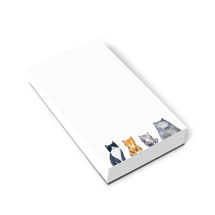 E. FRANCES PAPER's CATS NOTEPAD, made in the USA, features a minimalistic design with recycled paper and charming illustrations of black & white, orange, gray, and brown cats along the bottom edge. The crisp white background offers ample blank space.