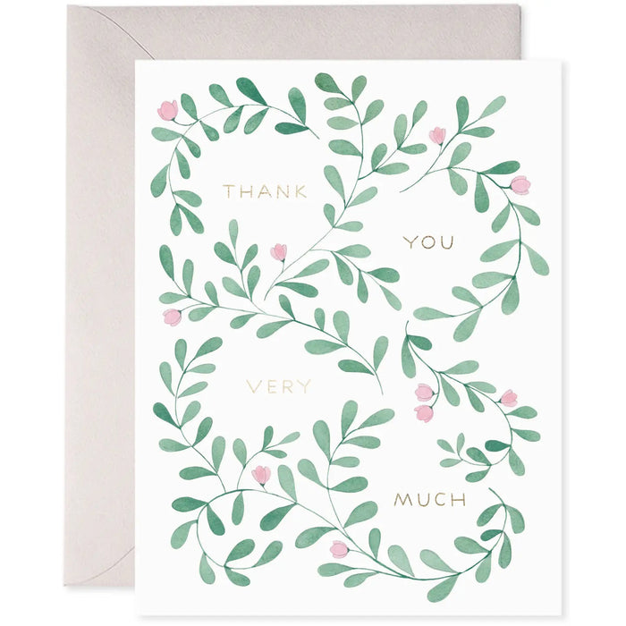 The E. FRANCES PAPER - THANK YOU VINE GREETING CARD from E. FRANCES PAPER showcases green leafy vines with small pink flowers around "Thank You Very Much" in gold foil on a white background, printed on luxe heavyweight paper for an elegant and refined expression of gratitude.