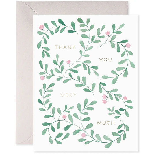 The E. FRANCES PAPER - THANK YOU VINE GREETING CARD from E. FRANCES PAPER showcases green leafy vines with small pink flowers around "Thank You Very Much" in gold foil on a white background, printed on luxe heavyweight paper for an elegant and refined expression of gratitude.