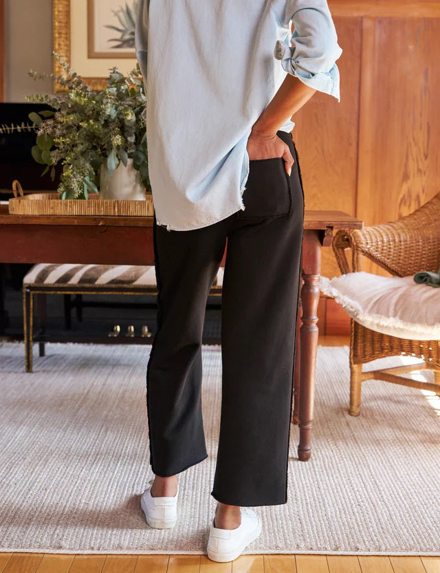 The FRANK & EILEEN BELLA Italian Sweatpant in black features a drawstring waist, side seam detail, and a lightly frayed hem, shown flat on a light textured background.
