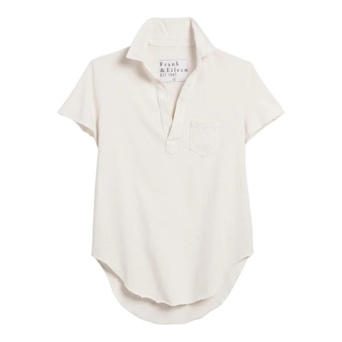 The FRANK & EILEEN Charlotte Perfect Polo Tee is a contemporary, short-sleeve polo shirt in off-white, featuring a collared neckline, an open V-neck, and a chest pocket. Displayed against a white background, the front pocket and inner label reading “Frank & Eileen EST 1947” highlight its distinctive design.
