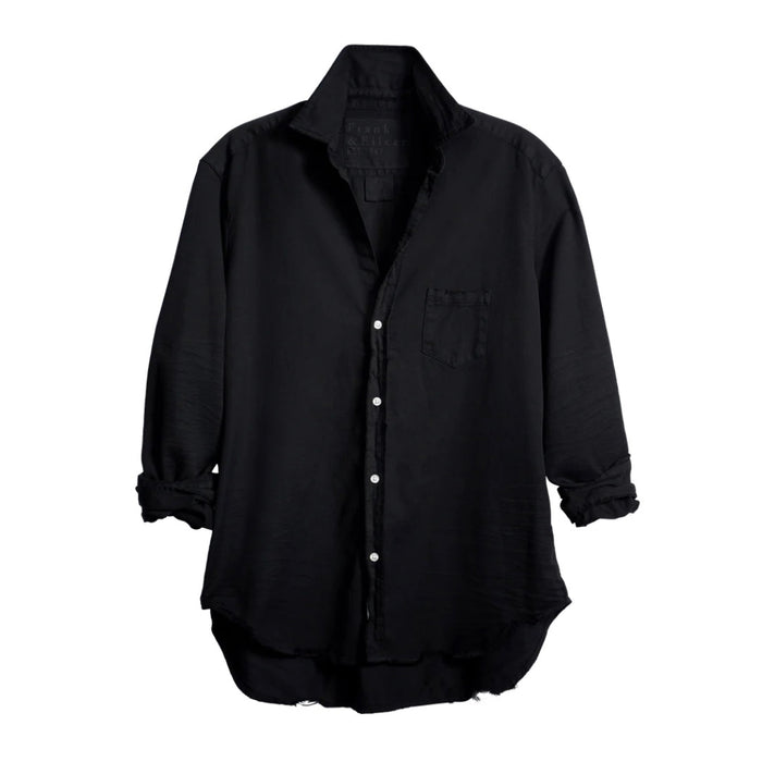 The FRANK & EILEEN Eileen Relaxed Button-Up in Black Tattered Denim provides a relaxed fit with long sleeves that can be stylishly rolled up. It includes a single breast pocket on the left side and features a slightly curved hem, complemented by bust-enhancing button placement for added elegance.