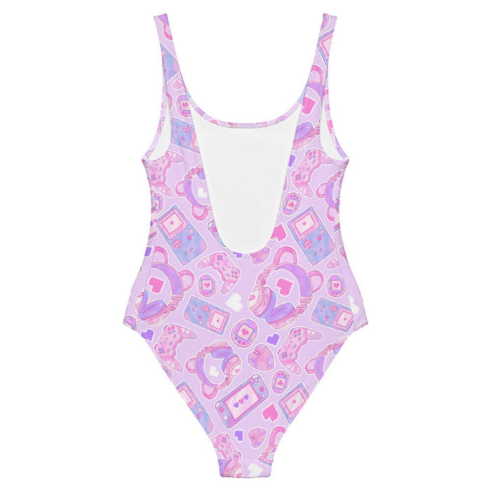 Gamer Girl kawaii one-piece swimsuit in pink with pastel controllers and Tamagotchi pets
