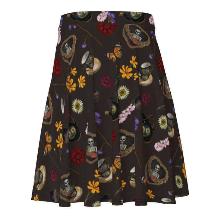 Gothic Tea Time skater skirt in black with a rose-clutching skeleton and white daisies, alternative attire