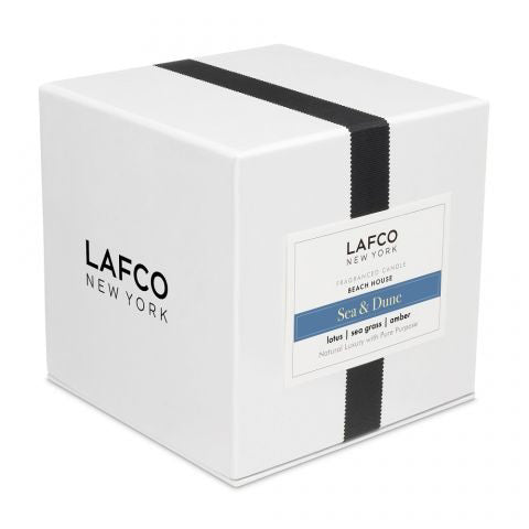 The LAFCO - SEA DUNE, BEACH HOUSE 6.5OZ features a clear glass tumbler with grey-tinted sides and a gold rim, its thick base casting a soft shadow to the right on a white background.