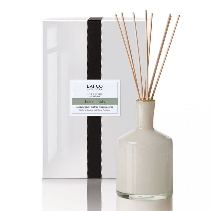 The LAFCO Ski House Feu de Bois Diffuser features a cream bottle, black ribboned box, and reeds to diffuse a sophisticated smoky leather scent.