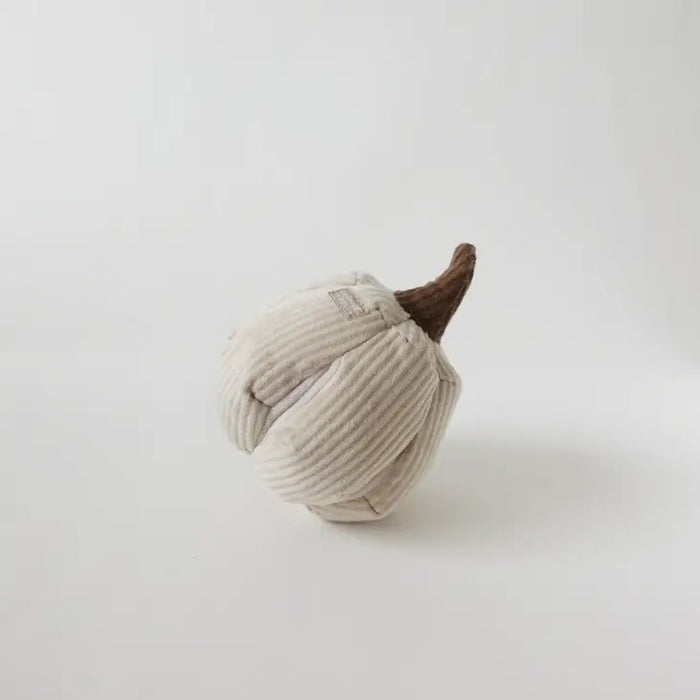 The LAMBWOLF COLLECTIVE - BOO DOG TOY is a plush, squeaky white pumpkin with ribbed fabric, treat pockets, and a textured brown stem from LAMBWOLF COLLECTIVE, shown on a plain white background.
