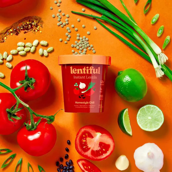 A green container of LENTIFUL - HOMESTYLE CHILI LENTILS with a dark green lid. The label features illustrations of green peppers, cilantro, and a beet. It highlights nutritional information: 12g protein, 7g fiber, 200 calories. Flavor: Mexican Green Chile, 2.65 oz. Shelf-stable for convenience.