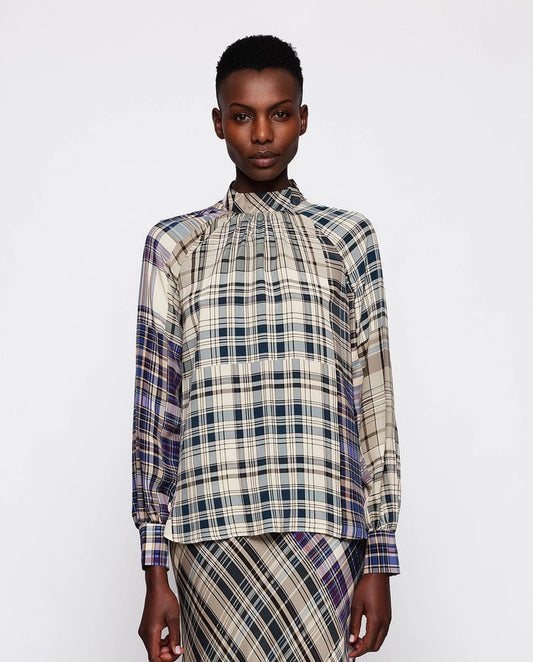 A person with short hair wears the MIRTO 1956 Silk Blend Plaid Blouse, standing against a plain white background.