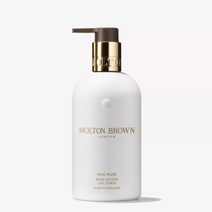 A white bottle of MOLTON BROWN - MILK MUSK BODY LOTION with a gold and brown pump and gold lettering, shown on a white background—a moisturizing lotion with a subtle floral musk scent from MOLTON BROWN.