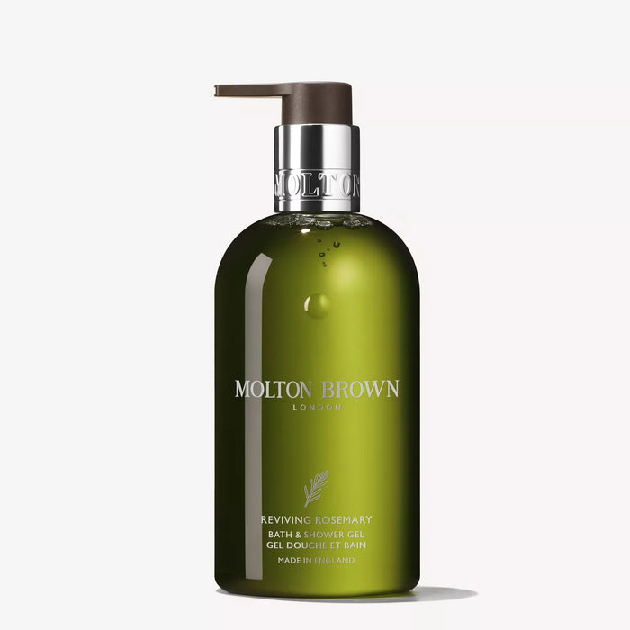 A green 300ml bottle of MOLTON BROWN Reviving Rosemary Bath and Shower Oil in Gel with a silver pump, shown against a white background. The label includes English and French text, highlighting its aromatherapy essential oils.