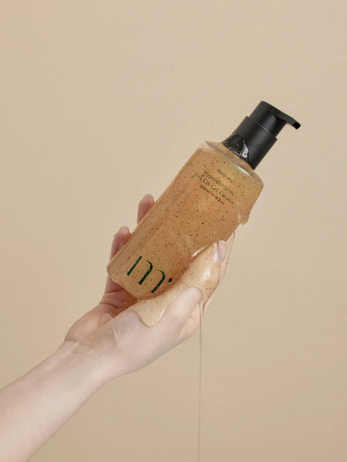 A Molovany Hypoallergenic LHA C18 Gel Cleanser bottle from Hong Cheon USA, Inc. features a black pump, light brown gel with darker specks for pore and dead skin cell reduction, and a label with black text.