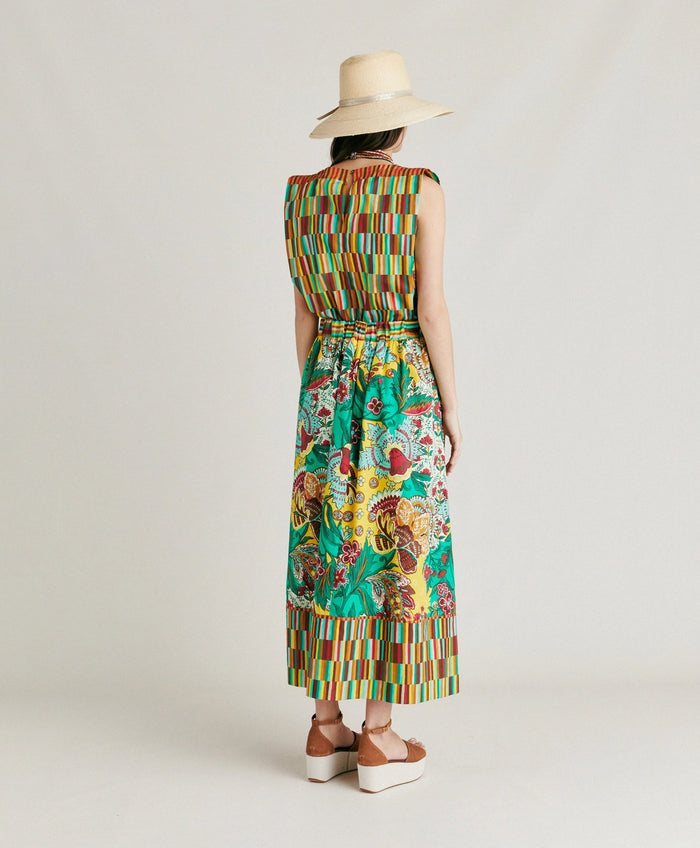 The MOMONI - IRIS SKIRT by MOMONI features vibrant yellow, green, and red floral prints on poplin with a geometric striped waistband and hem. Its flowy A-line silhouette offers effortless style.