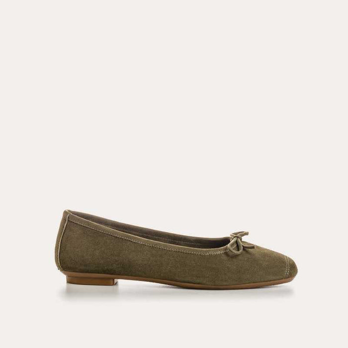 The REQINS - HARMONY suede ballerina flat in olive features a small bow on the toe, flat heel, and simple stitching, shown against a plain light background.