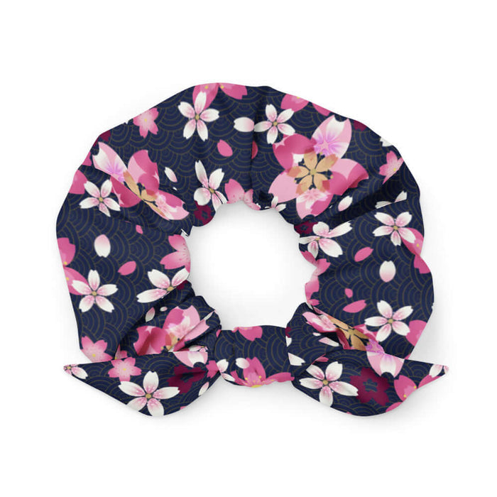 Sakura kawaii scrunchie in pink with drifting cherry blossom petals and golden wave arcs