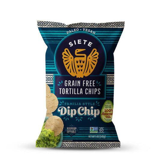 A blue bag of SIETE FOODS SIETE - TORTILLA DIP CHIP, labeled paleo and vegan. The bag features a gold bird logo, chips, and guacamole. 100% avocado oil is used for delicious chips in the "Dip Chip" flavor.