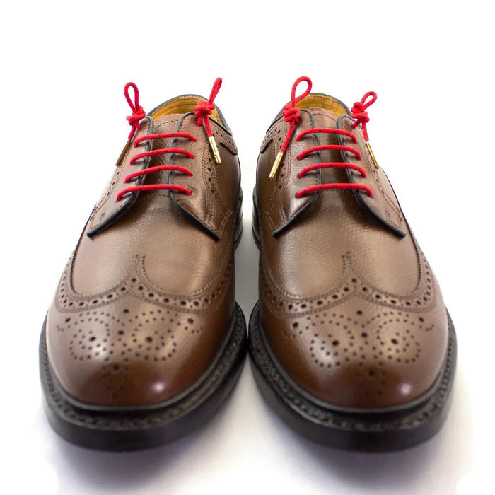 STOLEN RICHES Dress Shoelaces in Chaleo Red feature a colorful design with black dots and gold aglets, bundled with a white "Stolen Riches Since 1915" label. Made in Canada, these premium laces measure 54 inches.