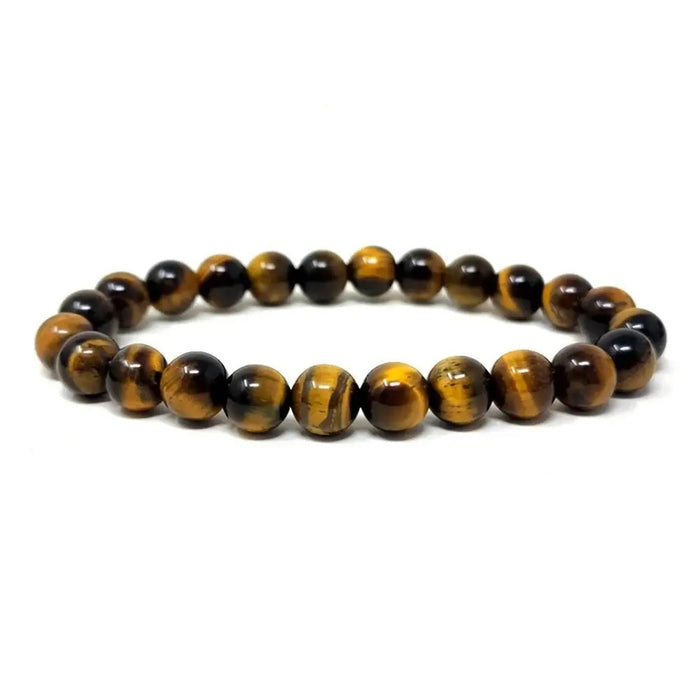 The STOLEN RICHES - MALLORCA TIGER EYE STONE BRACELET features polished round stones in brown and gold, arranged in a circular design to showcase grounding energy.