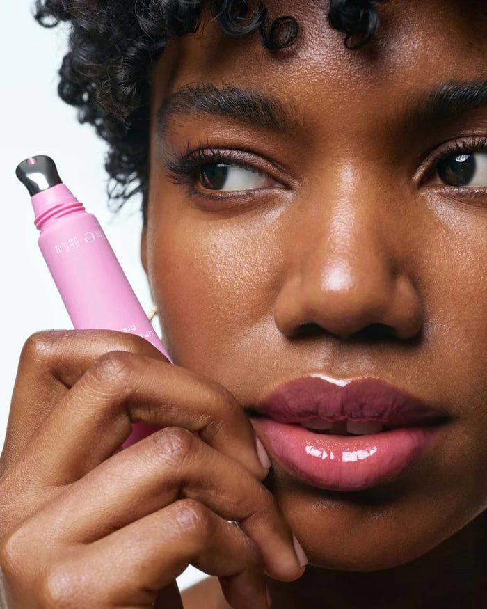 A pink tube of U BEAUTY - THE PLASMA LIP COMPOUND IN ORCHID stands upright on a light gray background, displaying the brand logo and product details in white text.