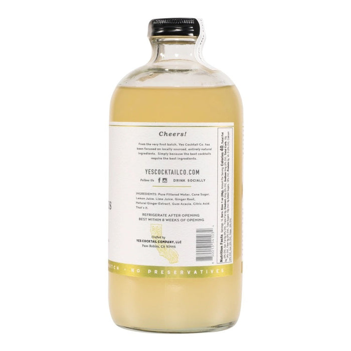 A clear glass 16 fl oz (473 ml) bottle of YES COCKTAIL CO - GINGER CITRUS COCKTAIL MIXER with a white label, green accents, and black text. The pale yellow mixer delivers a zesty ginger citrus kick—perfect for mule cocktails.